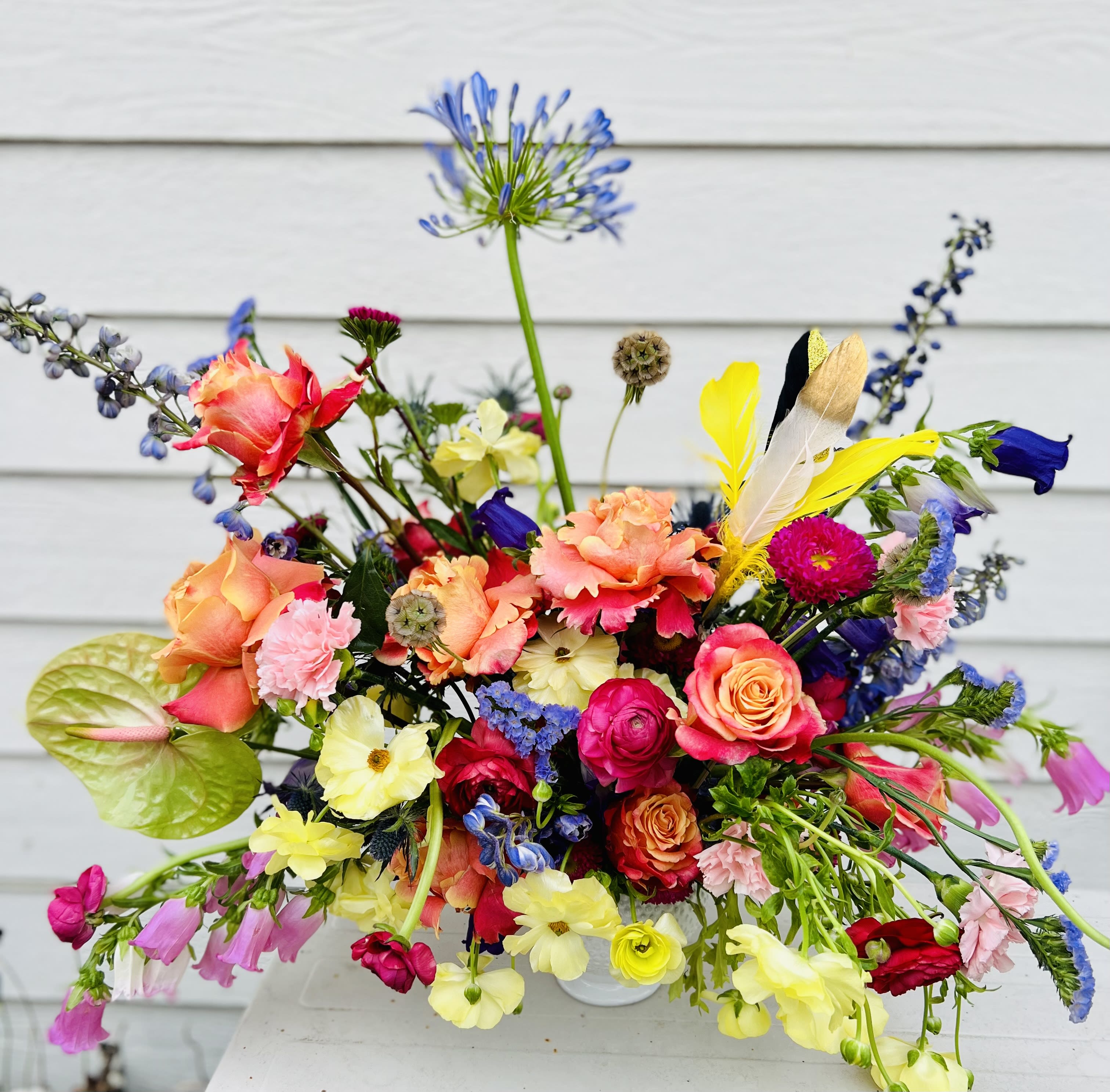 Retreat for the soul - Just looking at this  bright beauty brings you a since of being on vacation or visiting a beautiful retreat with flowers everywhere ... a little feather accent... *Flowers subject to change depending on availability 