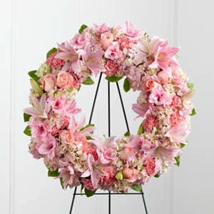 The FTD Loving Remembrance Wreath - The FTD® Loving Remembrance™ Wreath is a blushing display of grace and beauty to honor the life of the deceased at their final tribute. Pink roses Oriental lilies gladiolus hydrangea and carnations are brought together with lush greens to form the shape of a wreath offering warmth and comfort with its sweetly sophisticated elegance. Displayed on a wire easel.