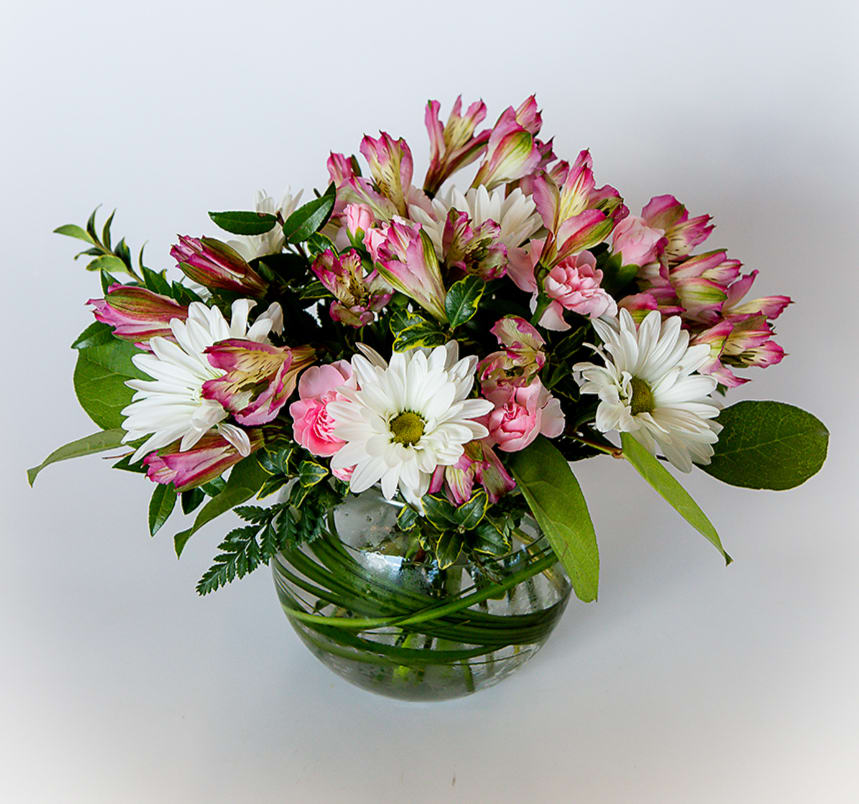 Flirty pinks - Beautiful mix of pink astro, mums, with green and pink accent flowers. Upgrade to deluxe and add 3 pink roses, or premium for 6 roses