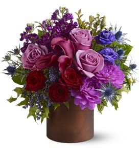 Jewel tone Gorgeous Jewel tone Gorgeous - Do you know someone who loves the color purple? For a truly luscious display, send them this plum-toned mix of blossoms in shades of purple, lavender and wine, arranged in a Teleflora Satin Collection container that will be reused again and again. It's like two gifts in one! A mix of fresh flowers such as roses, dahlias, lisianthus, miniature callas and stock, accented with preserved oak leaves and more, is arranged in a brown Teleflora Satin Collection cylinder. Approximately 12" (W) x 13" (H) Orientation: All-Around