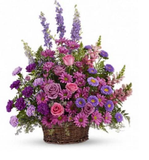 WICKER BASKET OF PURPLE WICKER BASKET OF PURPLE - A MIXTURE OF PURPLES IN A DARK WICKER BASKET