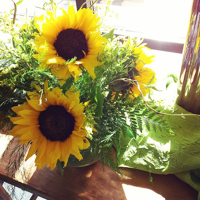 My Little Sunshine - A quaint and cheerful arrangement made with sunflowers, solidargo, leatherleaf ferns, salal, and other various greens. Dimension: 15&quot;x10&quot;  