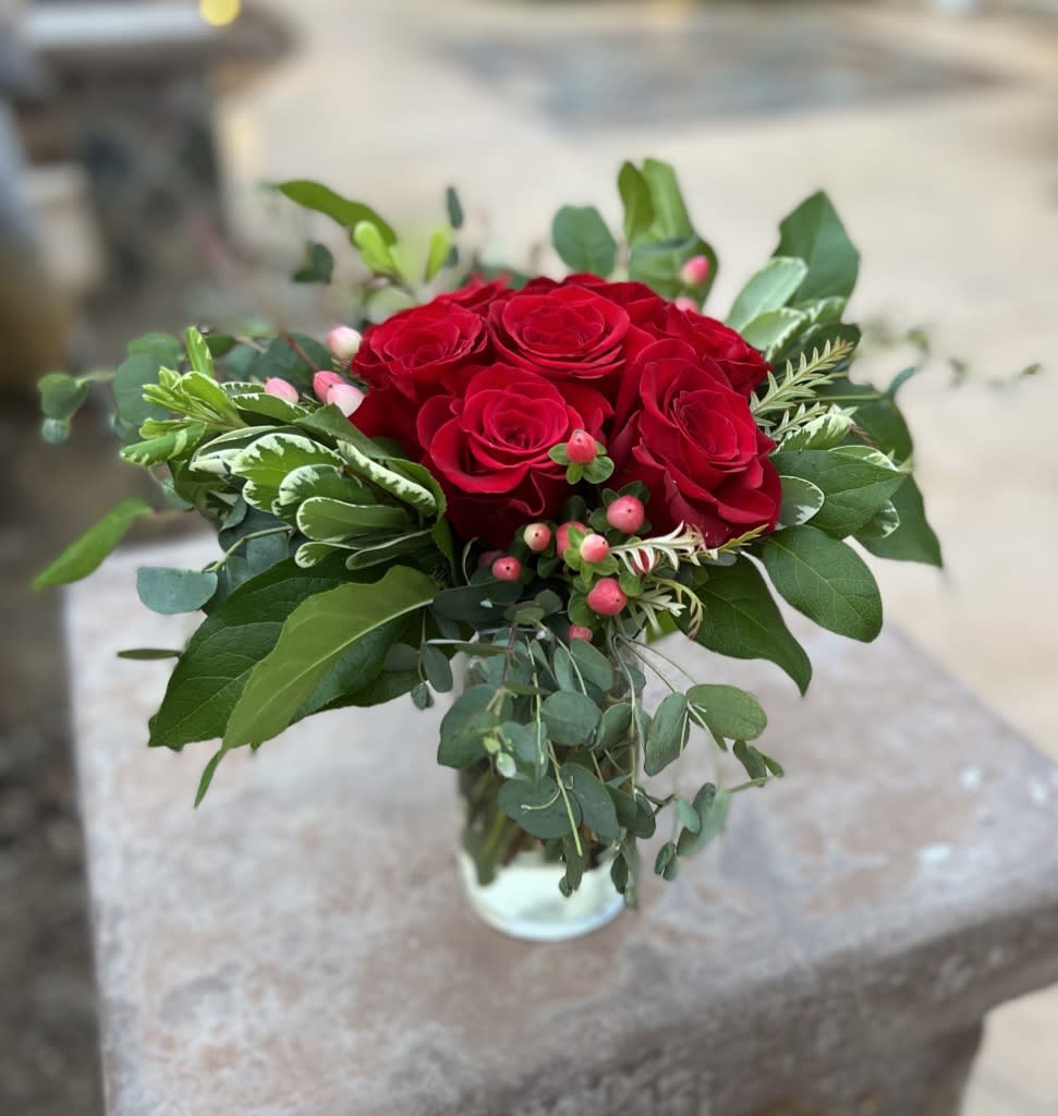 A flower made out of flowers A flower made out of flowers - What is it about symmetry that is so pleasing to the eye?! This lovely arrangement includes 7 tightly styled roses surrounded by a boarder of berries and several types of greenery. It looks just like a wildflower... made out of flowers.