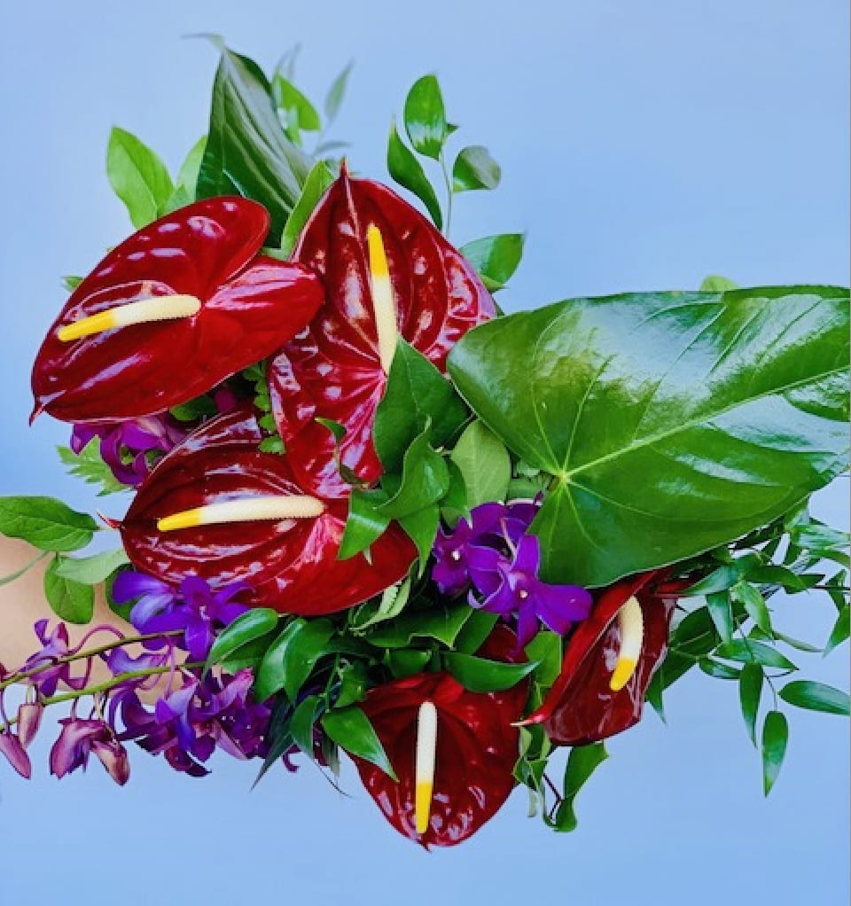 Hand-tied tropical bouquet - A combination of tropical foliage and tropical blooms designed to be placed directly in vase. The perfect display for a special occasion.  Please contact us directly for any custom orders or requests info@helemelebotanicals.com or 808.226.7667.  We are committed to malama 'aina and strive to use locally sourced material, reduce packaging and reuse and recycle where possible. We will pick up any of our product (vessels, plants and floral supply material) when delivering a subsequent order. At that time, a $5 credit toward future purchase will be issued for each ceramic, metal or wood vessel returned.