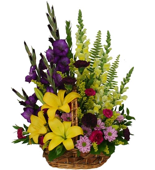 Sympathy Garden Flower Basket - Colourful garden-style basket arrangement overflowing with groupings of lilies, gladiolus, snapdragons, miniature carnations, carnations, daisies, solidago and greens. A truly inspired expression of your warmest condolences.