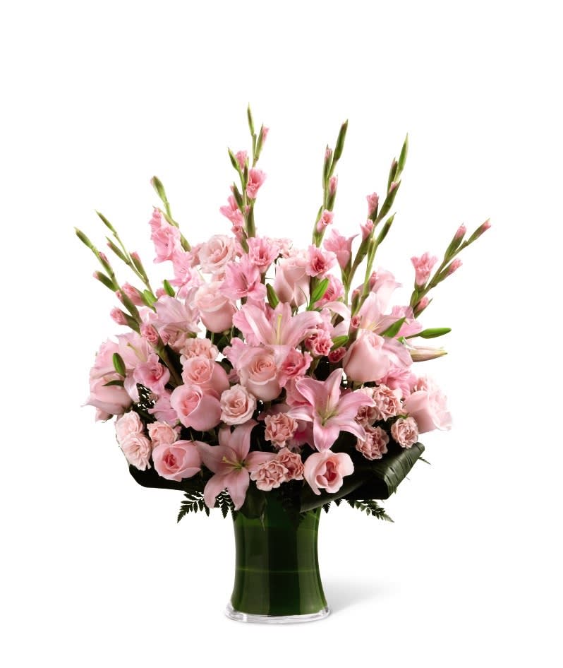 SAFF The Lovely Tribute Bouquet - The Lovely Tribute Bouquet is a warm and blushing display of peace and beauty, set to honor the deceased and bring comfort to family and friends. Pink gladiolus, pale pink roses, pink spray roses, pink Asiatic liles and an assortment of lush greens create a sophisticated arrangement seated in a clear glass gathering vase, symbolizing your heartfelt love and sympathy. GOOD bouquet includes 18 stems. Approximately 27&quot;H x 17&quot;W. BETTER bouquet includes 26 stems. Approximately 28&quot;H x 19&quot;W. BEST bouquet includes 33 stems. Approximately 30&quot;H x 22&quot;W.  Your purchase includes a complimentary personalized gift message.