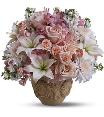 Teleflora's Garden of Memories - A garden of heavenly blooms offers an elegant and timeless tribute beautifully honoring the spirit of the most precious departed. Lovely fresh flowers such as white asiatic lilies and chrysanthemums pink roses hydrangea and alstroemeria all delivered in an exclusive Garlands of Grace urn.Approximately 19&quot; W x 18 1/4&quot; H Orientation: All-Around As Shown : T221-1A