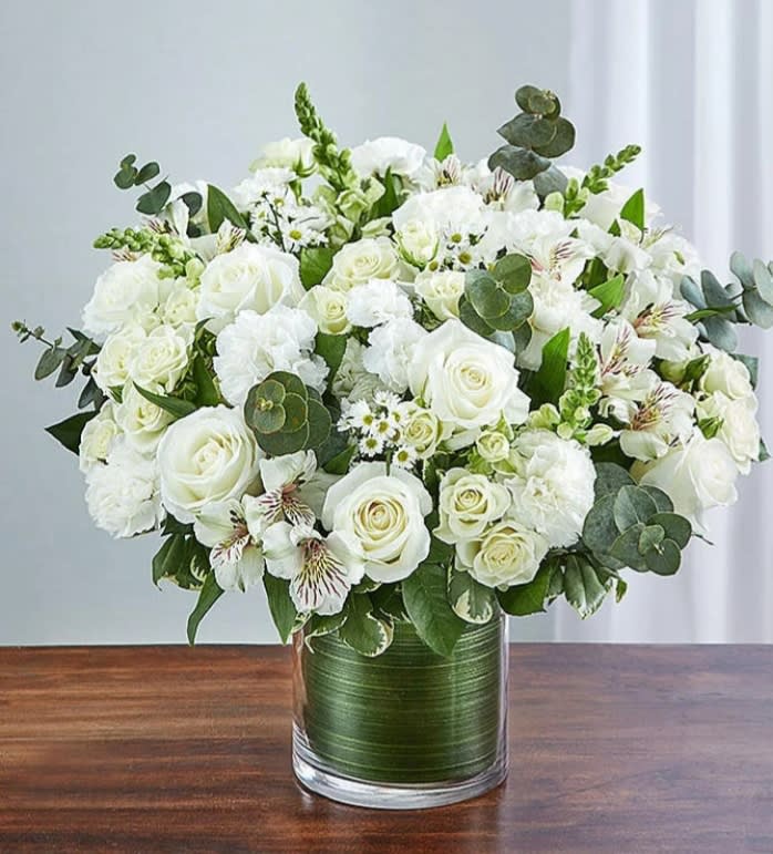Cherished Memories -all white Cherished Memories -all white - Memories are timeless treasures of the heart, meant to be cherished. Our striking, all-white sympathy arrangement of roses, snapdragons, alstroemeria and more, elegantly designed by hand in a graceful cylinder vase, is a touching tribute to a life well lived and the memories that will be held dear forever.