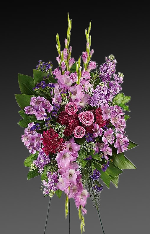 EC131 - Take a walk through the garden of memories with this lush spray of lavender and purple blooms, accented with fresh green ti leaves. It's a joyful expression of sympathy sure to be appreciated.