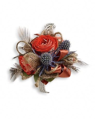 Boho Dreams Corsage - Impress them with this striking arrangement of blue eryngium, orange roses and fabulous pheasant feathers. Orange spray roses, blue eryngium and seeded eucalyptus with pheasant feathers.
