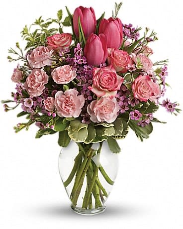 Full Of Love Bouquet - Spring into pink! Delicate roses, tulips and carnations fill a graceful vase with a cheerful expression of your love. It's affection perfection! Includes pink roses, tulips, carnations and waxflower, accented with fresh pitta negra and variegated pittosporum. Delivered in a lovely glass vase.
