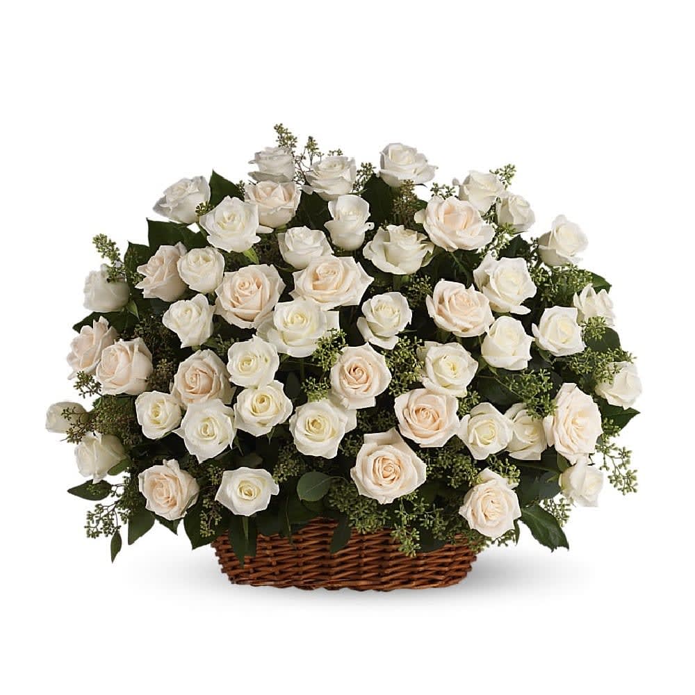 Bountiful Rose Basket - A beautiful, bountiful basket of luminous white roses that feels so fresh, natural, and welcomed in a home or at a service. White and cream roses with fragrant seeded eucalyptus beautifully presented in a large basket.