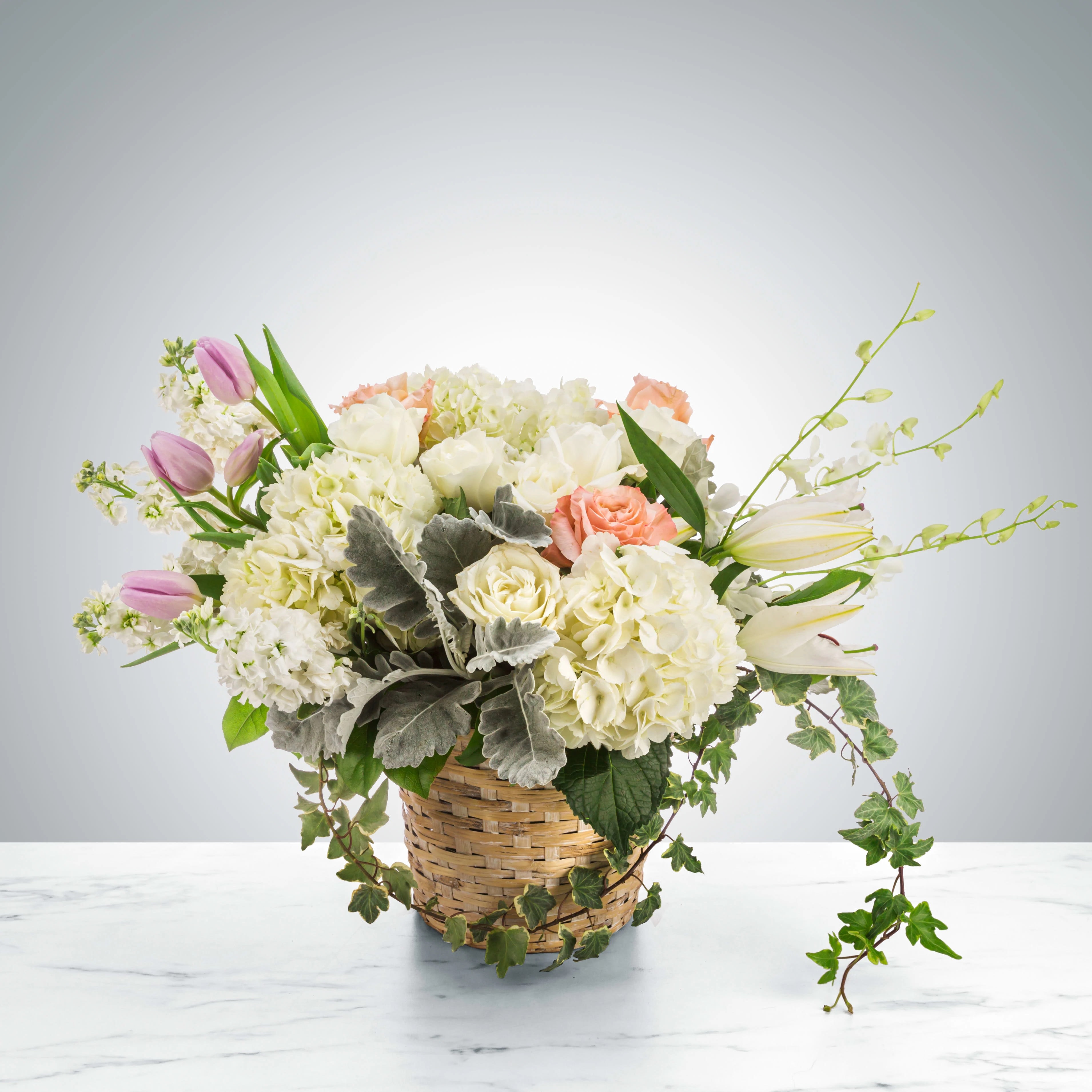 Lean on Me - A large pastel-colored basket suitable for sending to the home after the service, Lean on Me by BloomNation™ features roses, hydrangeas, tulips, ivy, and dendrobium orchids.  Approximate Dimensions: 18&quot;D x 12&quot;H
