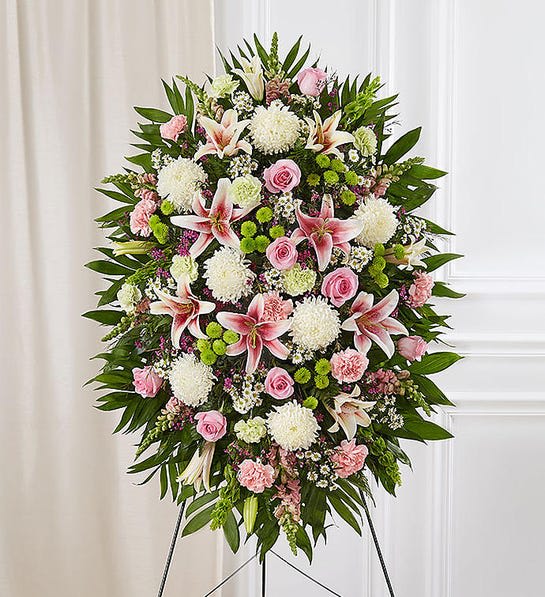 Pastel Sympathy Standing Spray - When we celebrate the life of a loved one, we honor their memory through heartfelt words and gestures. Our classic standing spray arrangement creates a graceful tribute, crafted with soft pastel blooms for a lush, full presentation. What a special way to remember someone so very loved.