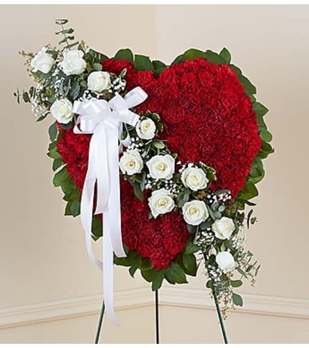 Red Solid Standing Heart with White Roses - Honor a loved one with a special tribute. Our heart-shaped standing arrangement of fresh red carnations, accented by a cascading sash of white roses adorned with a white satin ribbon, will help you elegantly express your sincere devotion and sympathy.