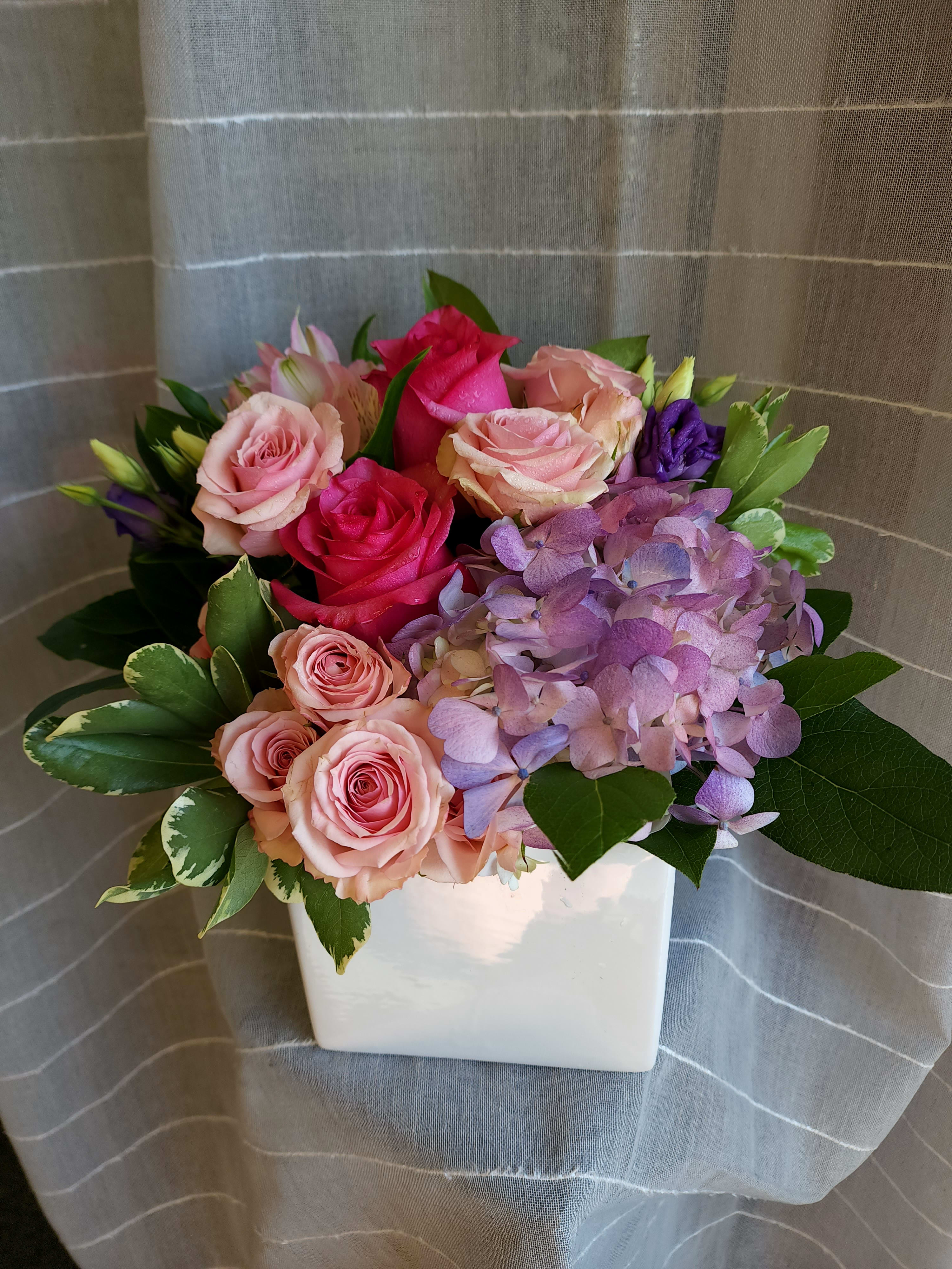 Penelope's Garden by MG Florist - Hydrangea, roses spray roses, alstroemeria mixed greenery designed in a ceramic white cube.