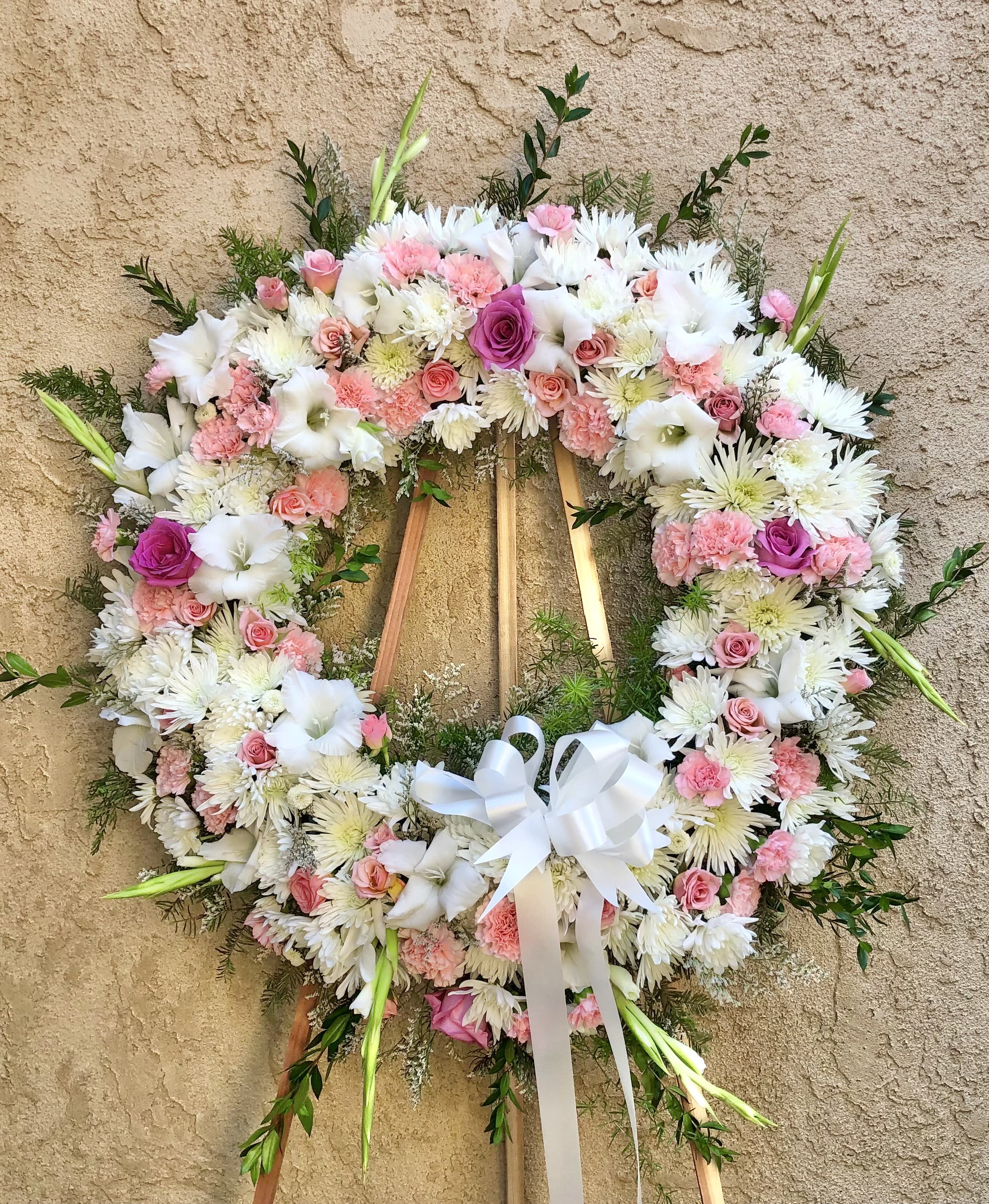 Sorbet - Beautiful standing funeral spray arrangement with mixed pink and white flowers with green accents. Featuring carnations, mums, gladius, roses, and accents.
