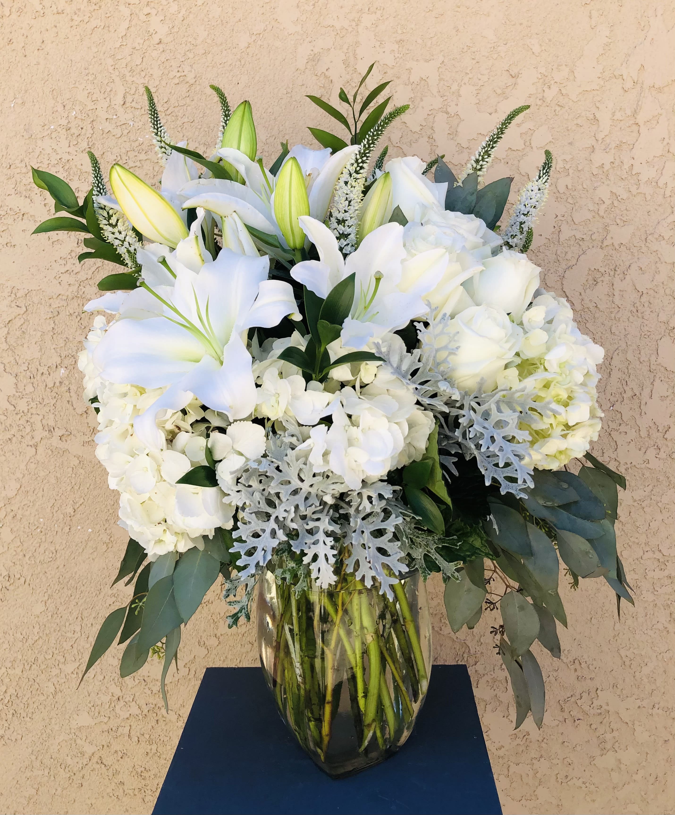 Light Of Your Life - Beautiful arrangement of white and silver mix of flowers. Featuring roses, lilies, hydrangeas, with silver and green leaf accents.