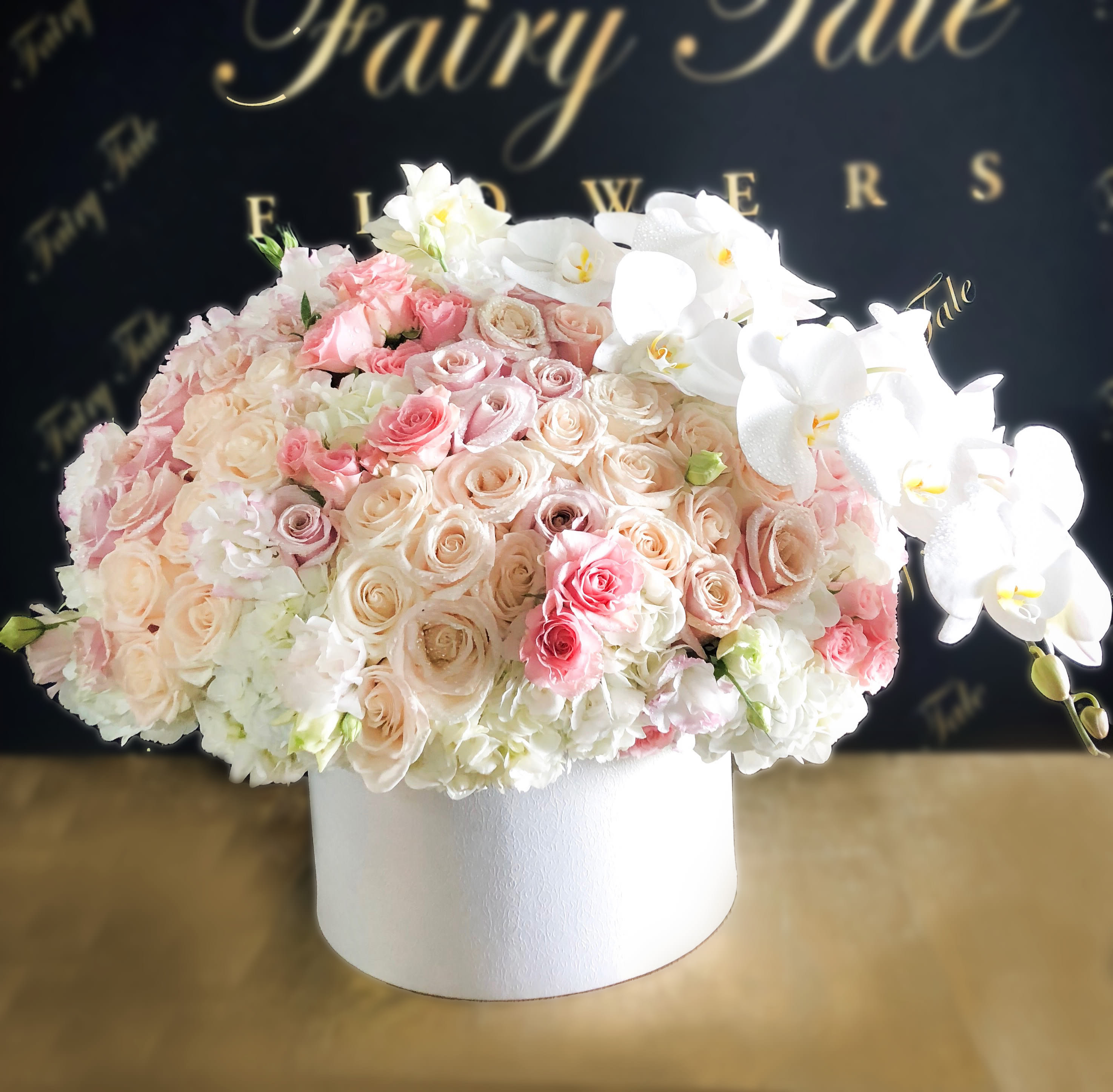 Bright Love - A pure beauty of bright roses, spray roses, hydrangeas, and orchids  
