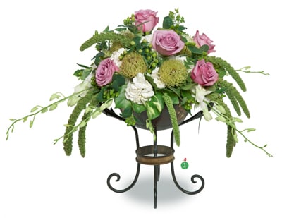High Style - When you need a floral arrangement that’s the height of elegant style, this stunning display will create a stir. With a mix of roses, white blossoms and ornamental greenery – and presented in a classic pedestal bowl – it’s just right for any occasion.   Container will be similar as possible. Purple Rose shade may vary from light to dark
