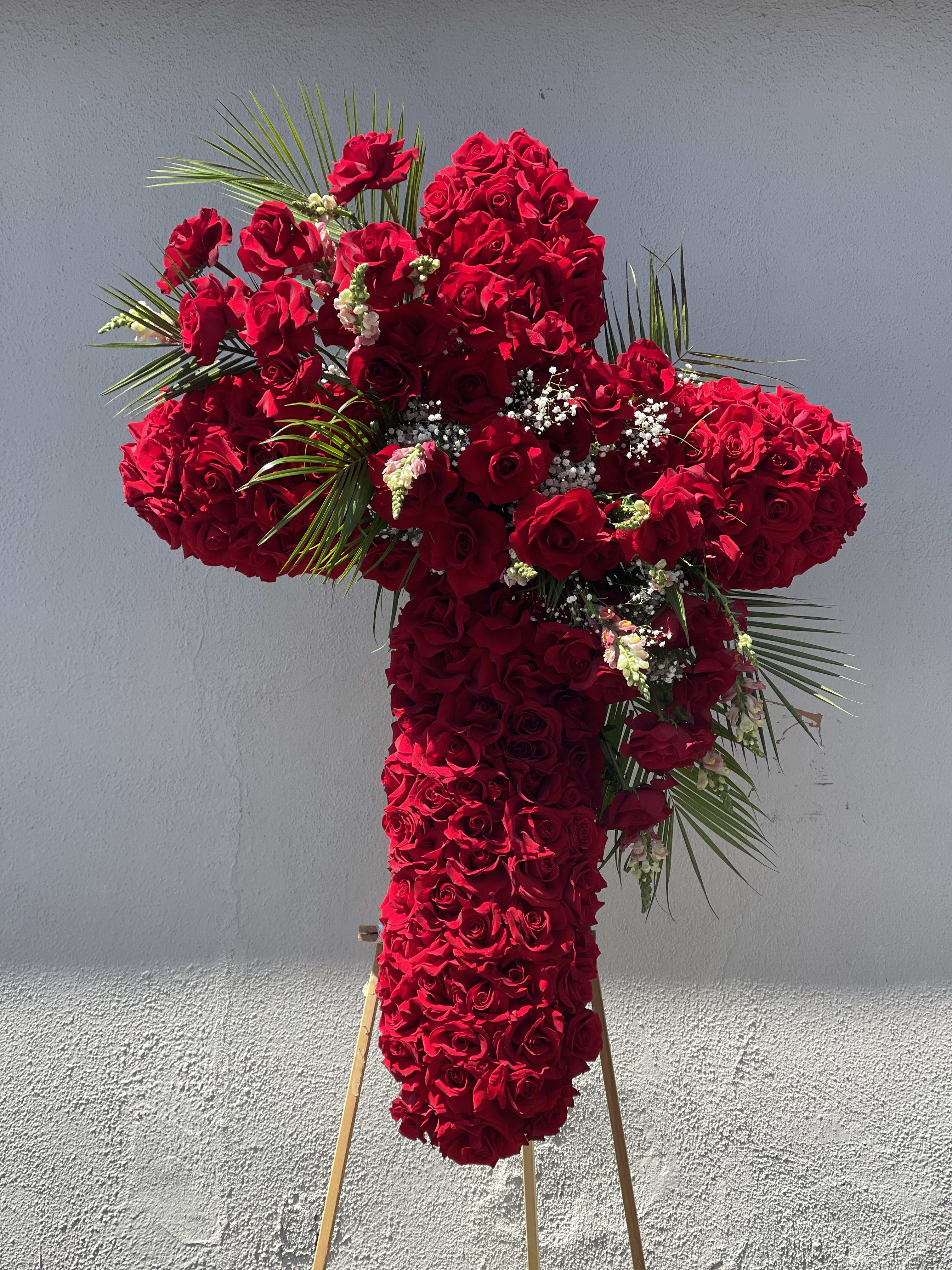 Red love - A 42 inch red rose cross with a beautiful arrangement in the middle