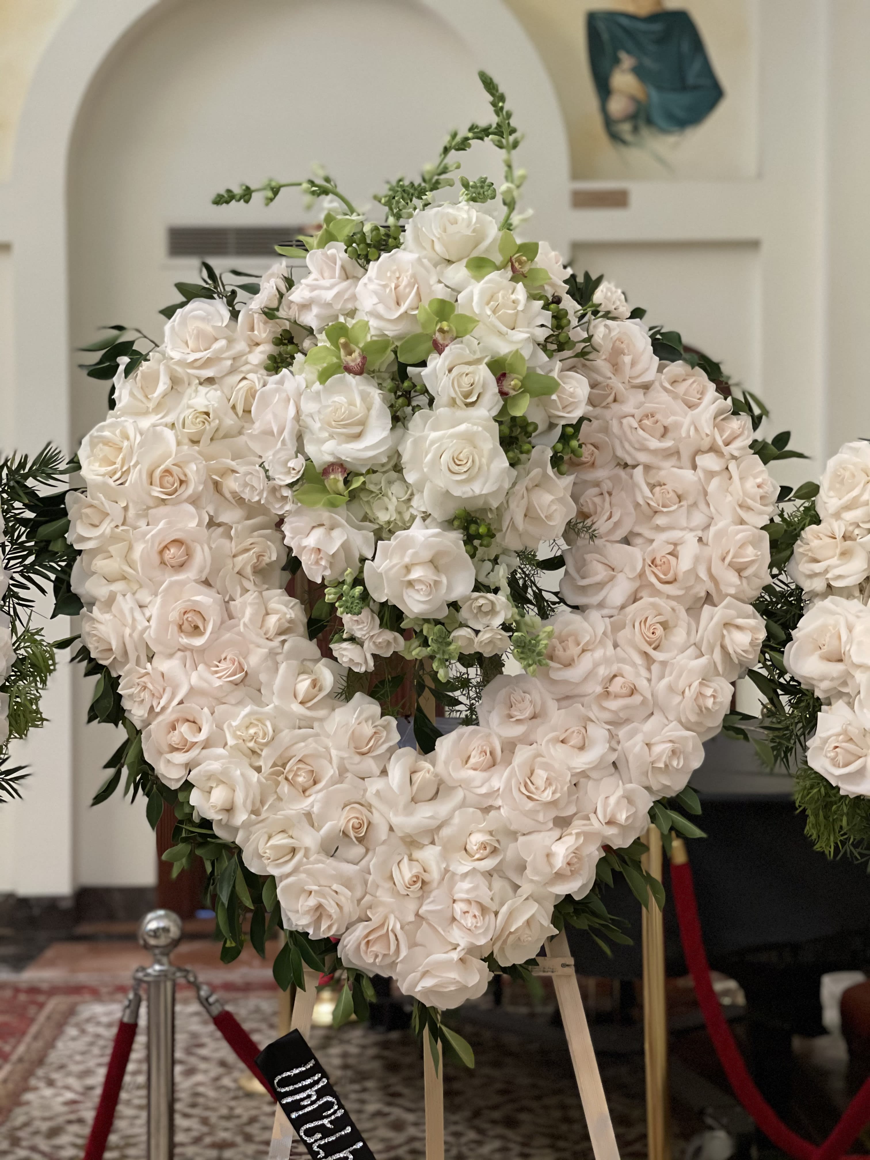 White love - A heart shaped beautiful arrangement with white roses green cymbedeums and green coffer beans