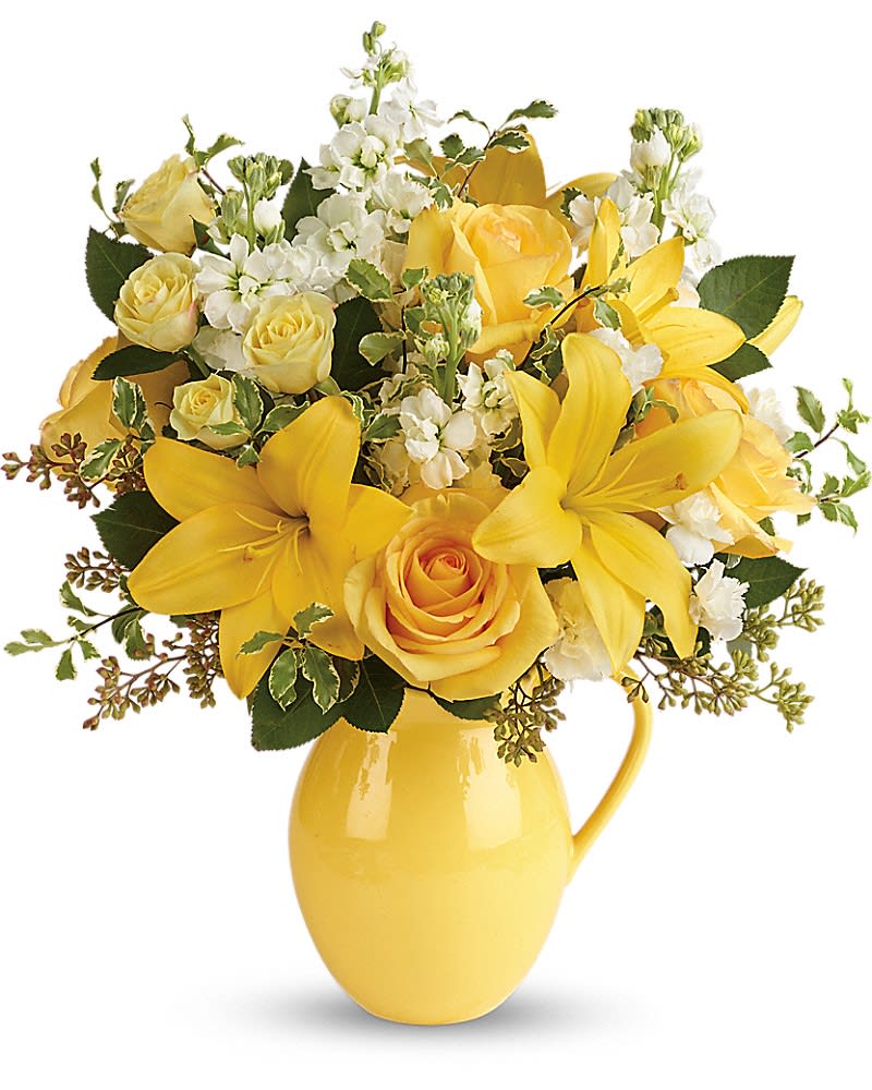 Teleflora's Sunny Outlook Bouquet - Brighten anyone's outlook with this sunshiny array of blooms! A heartwarming choice for a special day, or just because, these glorious roses and lilies are hand-delivered in a fabulous, food-safe pitcher they'll enjoy at breakfast for years to come! This bright bouquet features yellow roses, yellow spray roses, yellow asiatic lilies, white miniature carnations, white stock, seeded eucalyptus and pitta negra. Delivered in a Sunny Day pitcher.