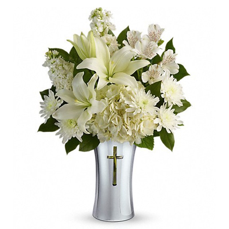 Teleflora's Shining Spirit Bouquet Teleflora's Shining Spirit Bouquet - Show your sympathy with style and grace. A shining silver finish and reverent cross cut-out makes this stunning ceramic vase the perfect accompaniment for a lush bouquet of pure white hydrangea, lilies, alstroemeria and stock. White hydrangea, white asiatic lilies, white alstroemeria, white stock, and white cushion spray chrysanthemums are accented with lemon leaf. Delivered in a Shining Cross vase. Orientation: One-Sided All prices in USD ($) Standard T277-1A Deluxe T277-1B Premium T277-1C
