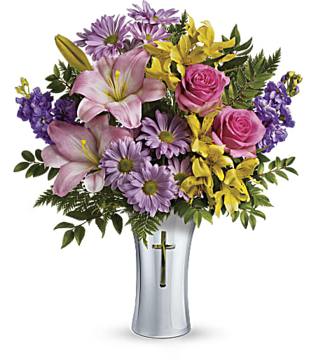 Teleflora's Bright Life Bouquet - Show them how much you care with this beautifully bright yet reverent arrangement of roses, lilies and alstroemeria. Gracefully presented in a shining, silver-finished ceramic vase with cross cut-out - a touching tribute to a bright life.  This glorious arrangement includes hot pink roses, pink asiatic lilies, yellow alstroemeria, lavender stock, lavender daisy spray chrysanthemums, and greenery. Delivered in a Shining Cross vase. Approximately 16 1/2&quot; W x 20&quot; H
