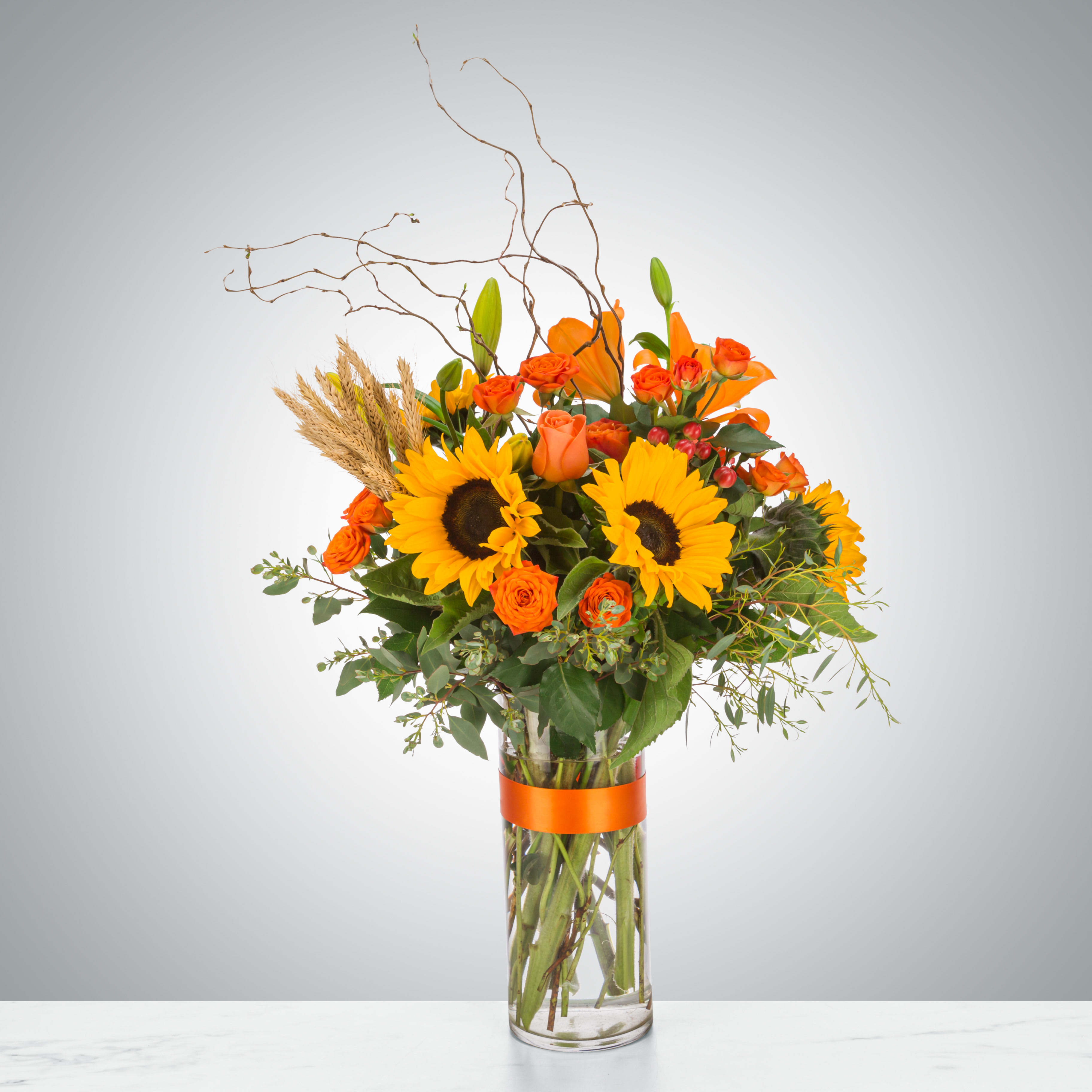 Hayride by BloomNation™ - The ultimate fall flower mix featuring sunflowers and a variety of orange flowers with eucalyptus and curly willow accents. Send this arrangement for Halloween, Thanksgiving, or to celebrate the season!  Approximate Dimensions: 18&quot;D x 29&quot;H