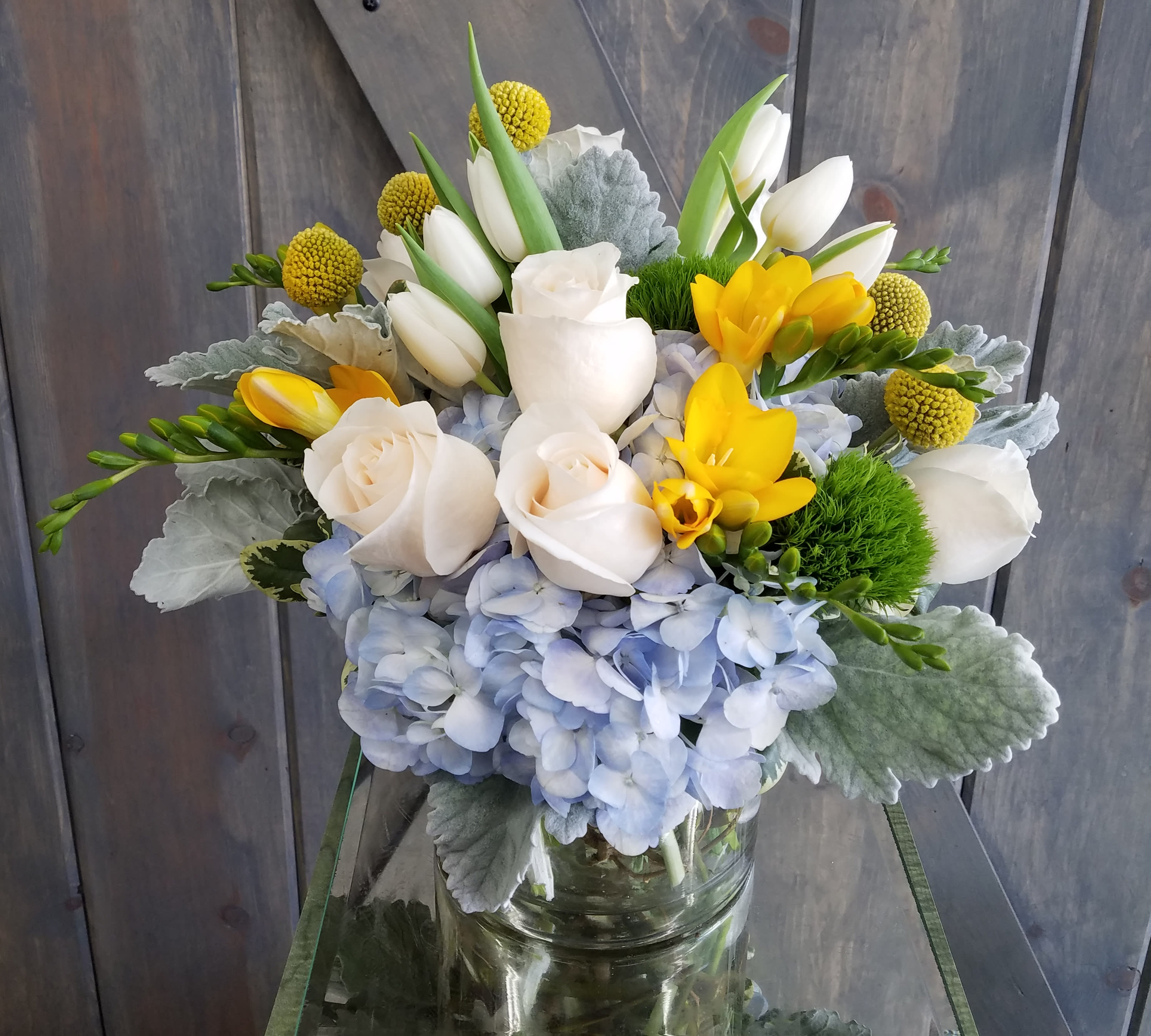 Little Blue - Included in this design are hydrangea, Roses, Freesia, Tulips, Billie Balls, Dianthus, and Dusty Miller