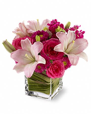 Posh Pinks - Show impeccable taste when you send this stylish bouquet of hot pink roses, pale pink lilies and mixed blossoms, arranged in a modern glass cube vase. Pretty, posh and perfectly high-class!  Hot pink roses and Matsumoto asters, pink LA hybrid lilies and burgundy stock arrive in a clear glass Teleflora cube vase lined with variegated ti leaves.  Approximately 11 1/2&quot; W x 11&quot; H  Product ID: T05N100A