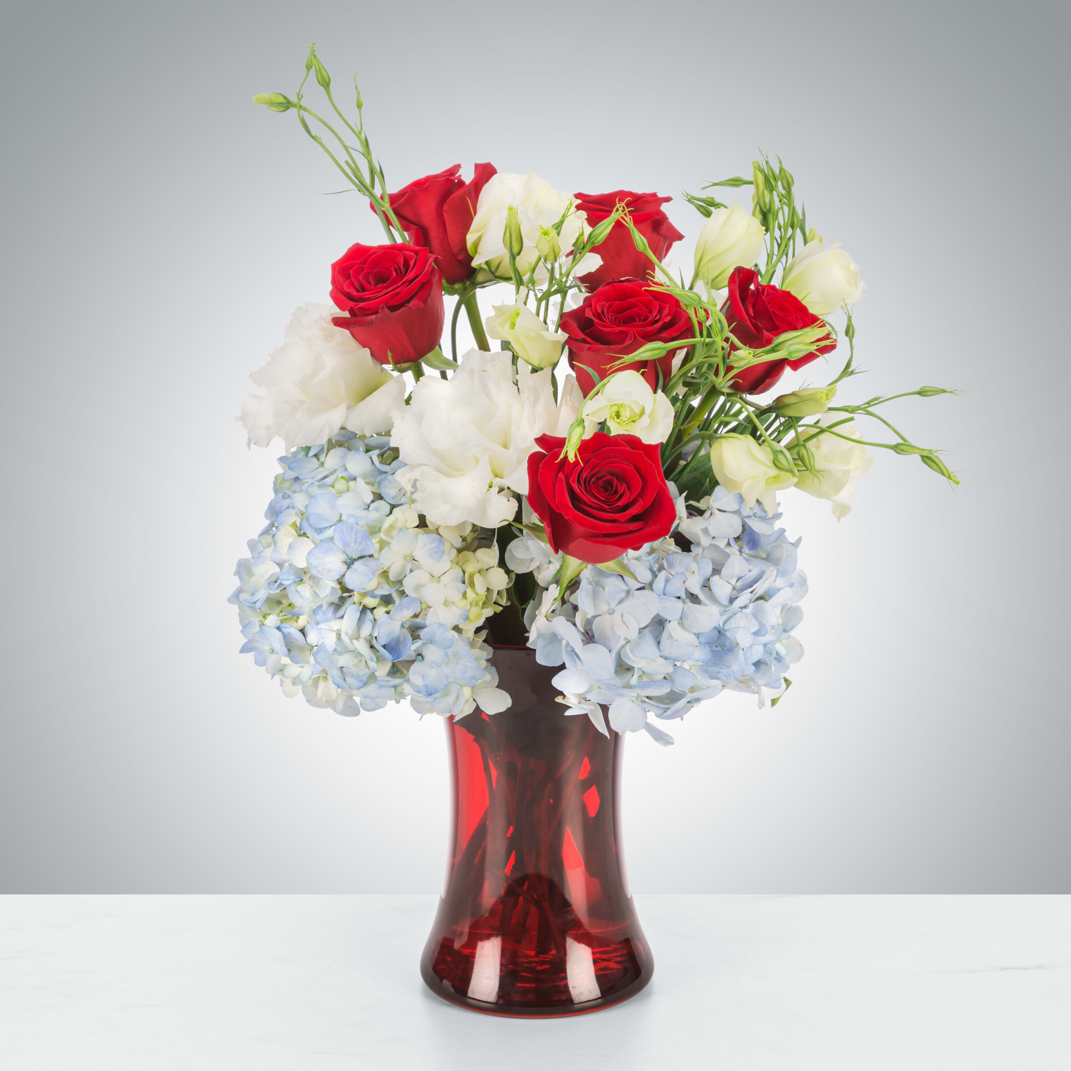 Americana  - Celebrate America with this red, white, and blue arrangement. Perfect for sending as a thank you gift for a Fourth of July cookout or sending on Memorial Day.  Approximate Dimensions: 11&quot;D x 16&quot;H