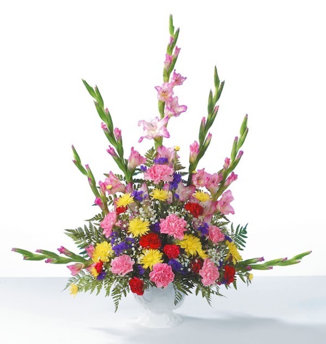 Garden Gathering - Pink Gladiolus radiate from a garden of Red and Pink Carnations, Yellow Cushion Pompons and Purple Statice in this memorable sympathy arrangement.