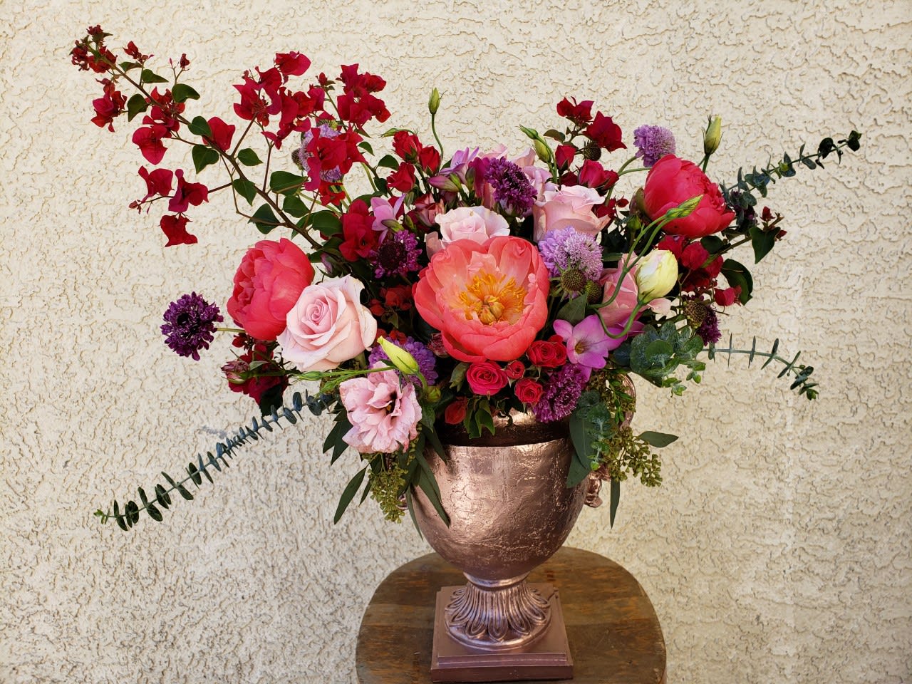KA-Bloom - Your gift of opulence will surely be on floral display with an abundance of Peonies, Roses, Freesia, and seasonal greens. This arrangement will certainly make 'em say &quot;KA-Bloom!&quot;