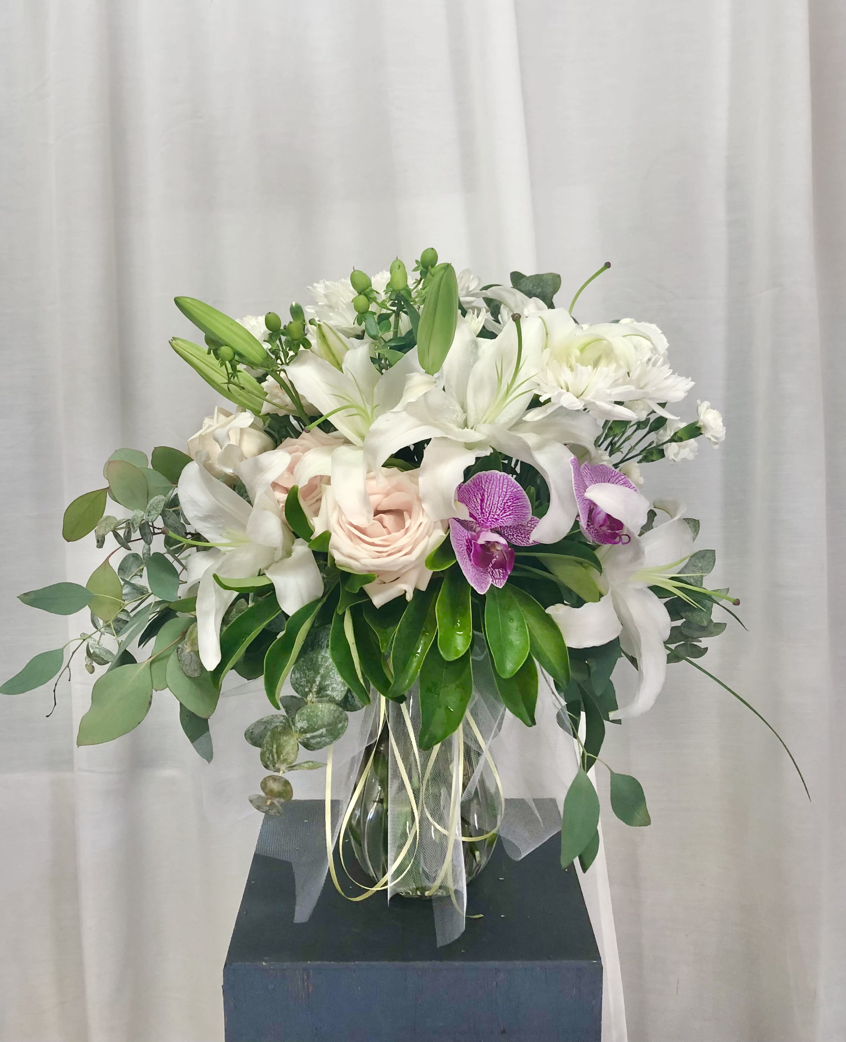 Cascading Memories - Beautiful and elegant arrangments of lillies, roses, orchid, , carnations, daises, and green accents.