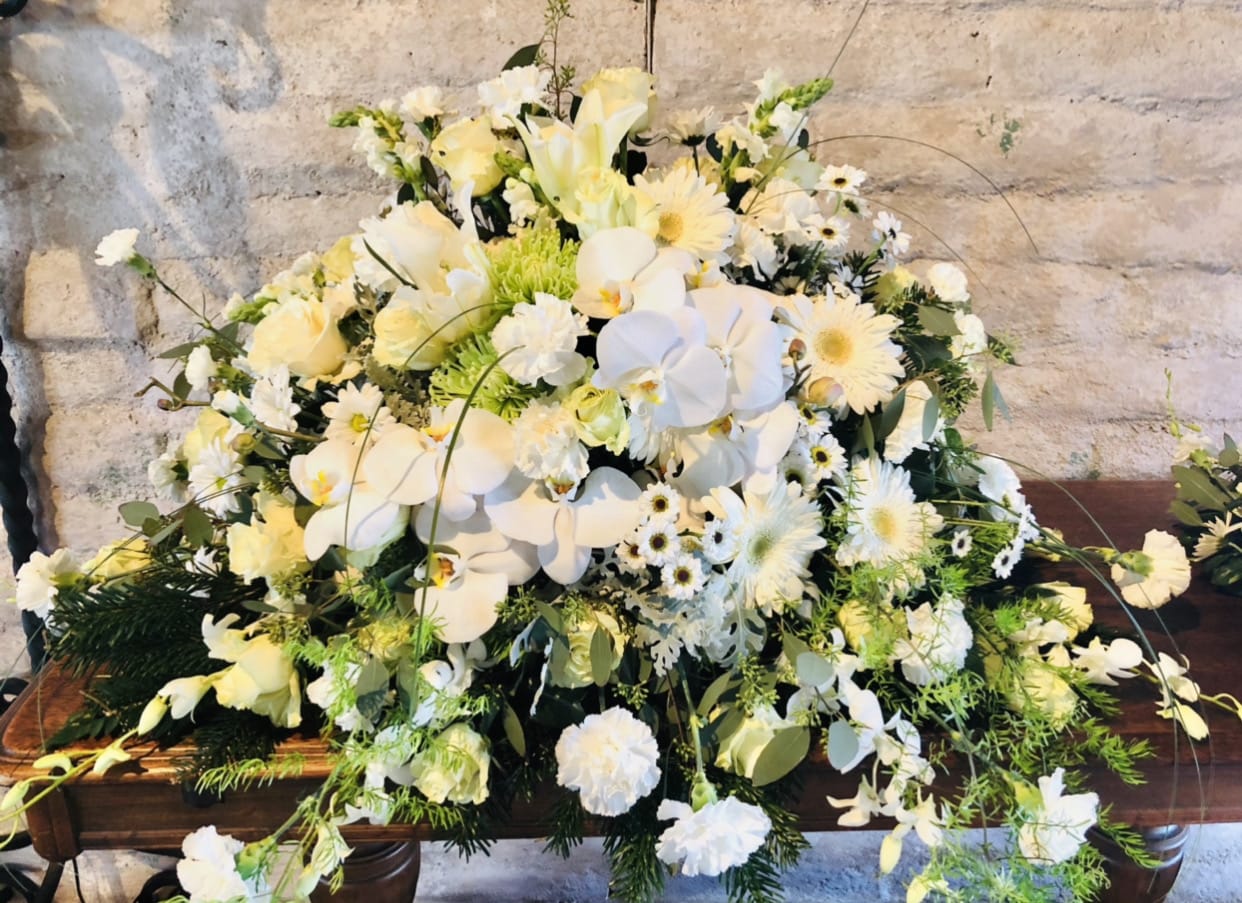 Casket 5 - Beautiful yellow and white casket arrangment featuring lilies, daises, carnations, gladius, with green accents.