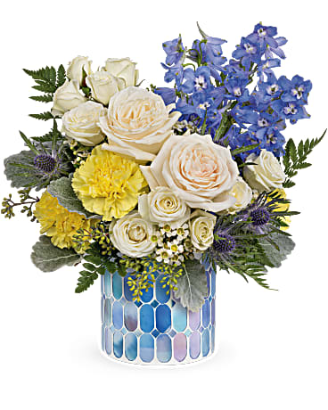 Blue Dream  Arrangement - This breathtaking bouquet includes white spray roses, light blue delphinium, blue eryngium, white waxflower, yellow carnations, seeded eucalyptus, dusty miller and leatherleaf fern with a  Blue Beauty Mosaic.