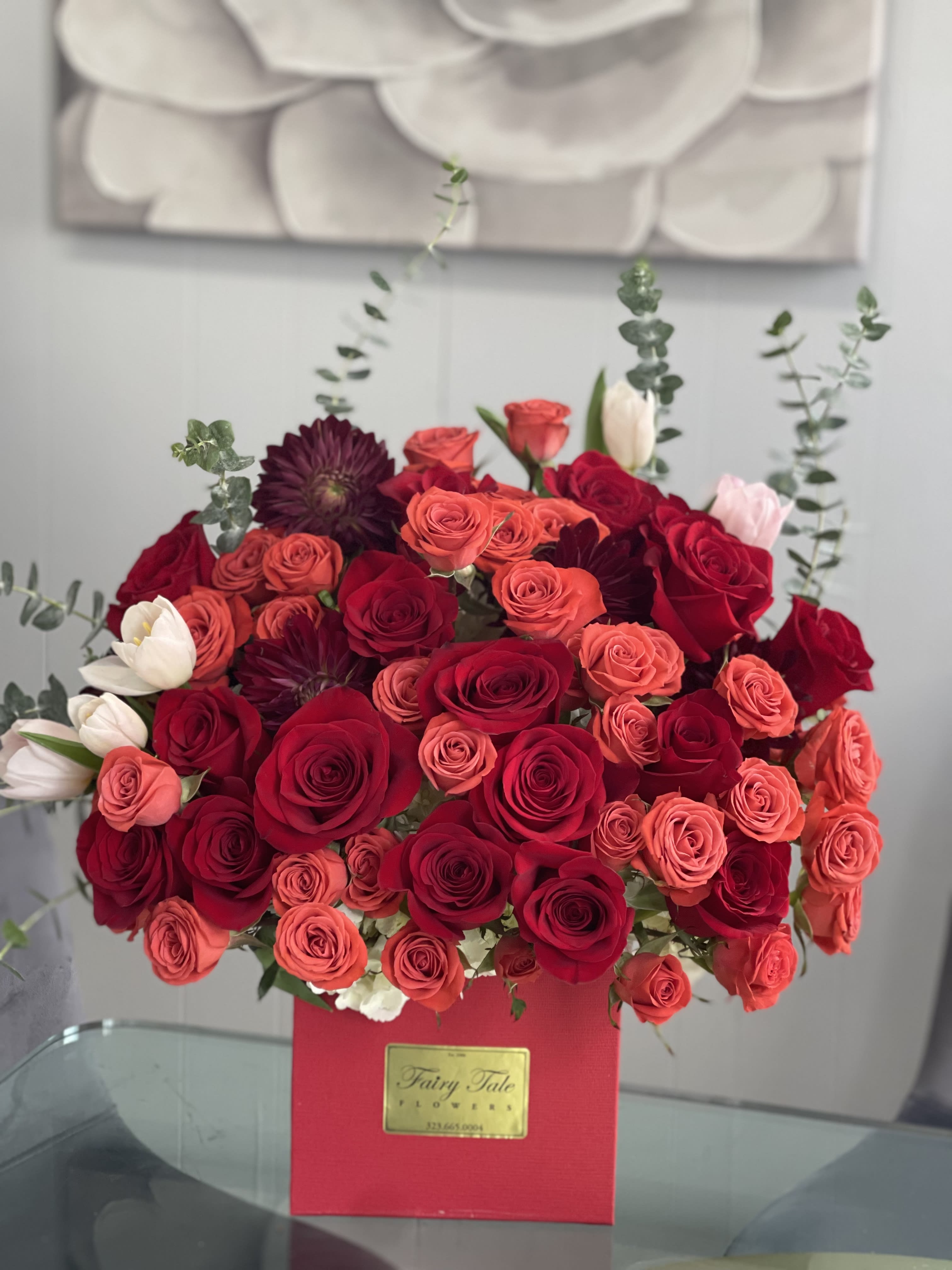 Coral path - A beautiful arrangement with red roses, coral spray roses and tulips In out square red box 