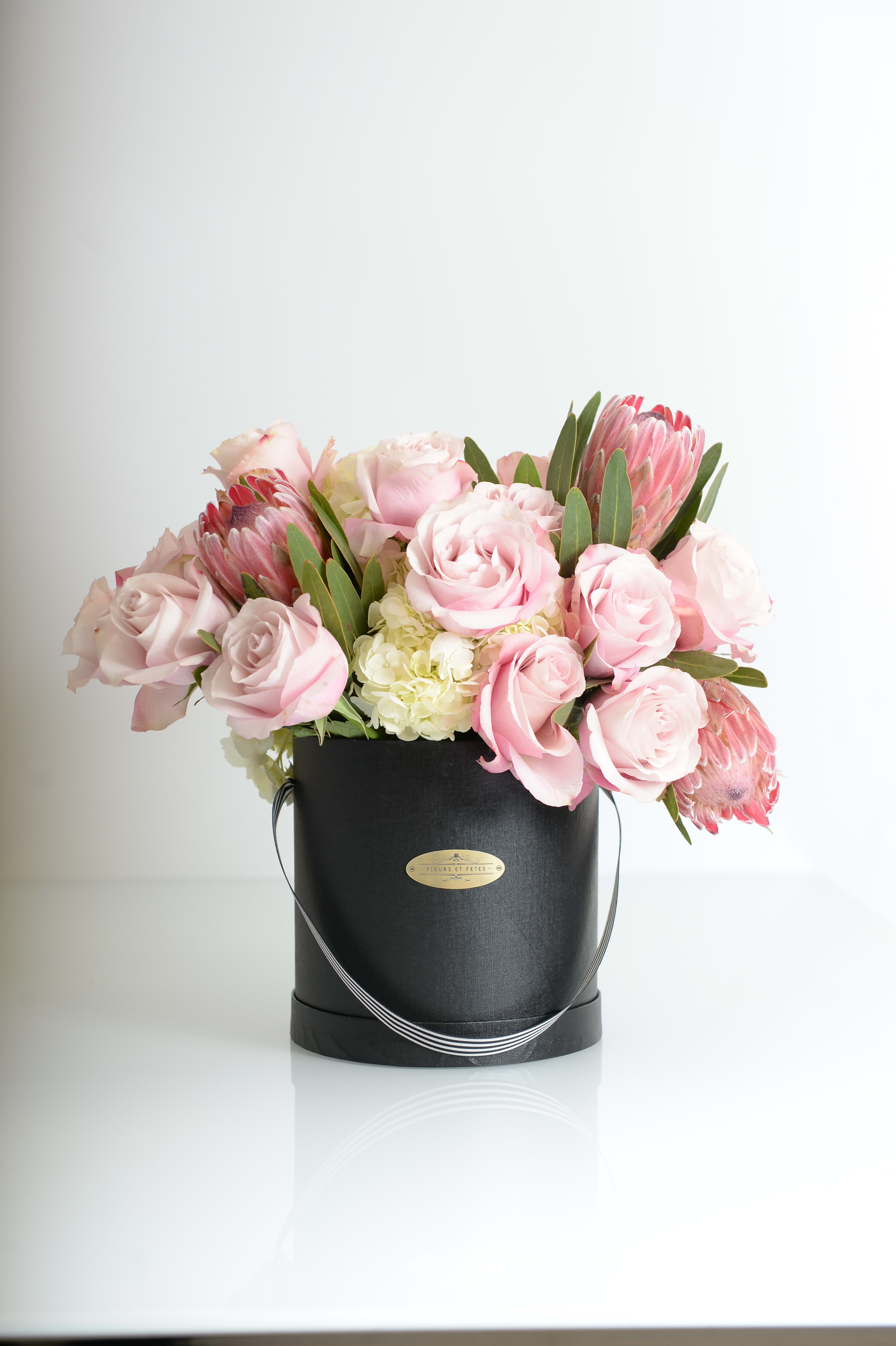 Rose Quartz - Featuring fresh flowers. The soft pink roses show unconditional love and compassion. Designed in large Fleurs et Fetes box.   *Due to Covid-19, some flowers may not be available. Fleurs et Fetes reserves the right to adjust the flowers and color depending on availability* 