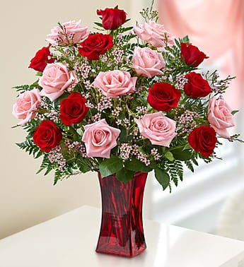 Shades of Pink and Red - Premium Long Stem Roses - Product ID: 91457  EXCLUSIVE She'll be blushing for sure when our beautiful bouquet of pink and red long-stem roses arrives at the door! Hand-gathered by our expert florists in a rich red vase, we canât think of a more colorful way to express yourself to someone very special. Gorgeous bouquet of premium long-stem pink and red roses, accented by fresh waxflower and salal Artistically arranged by our expert florists in a stylish red glass gathering vase; measures 9&quot;H Large arrangement has 18 stems; measures approximately 20&quot;H x 14&quot;L Small arrangement has 12 stems; measures approximately 18&quot;H x 12&quot;L Our florists select the freshest flowers available so colors and varieties may vary