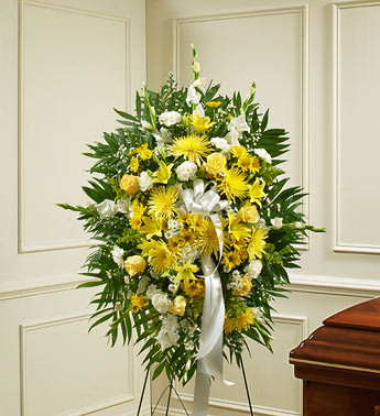  Deepest Sympathies Standing Spray - Yellow   91284  - This Sympathy Standing Spray, in yellow and white, is a beautiful reflection of your sympathy and support. Yellow and white flowers such as roses, Asiatic lilies, gladiolas, carnations and more An appropriate gift for family, friends and business associates to send directly to the funeral home Our florists use only the freshest flowers available, so colors and varieties may vary. Flowers in this arrangement are especially subject to seasonal availability. Therefore, suitable substitutions may need to be made. DUE TO THE NATURE OF THIS ARRANGEMENT, A MINIMUM NOTICE OF 24 BUSINESS HOURS MAY BE REQUIRED.