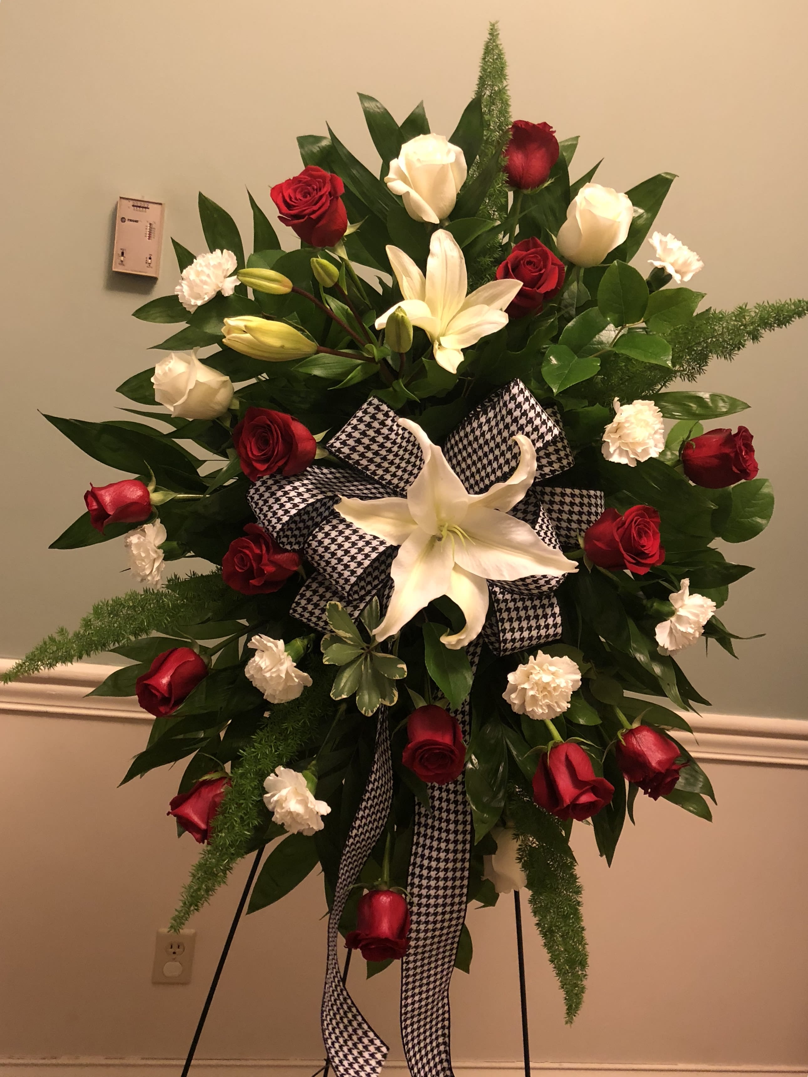 Houndstooth Spray  -   A beautiful easel spray with red and white flowers and the beautiful hounds tooth ribbon 