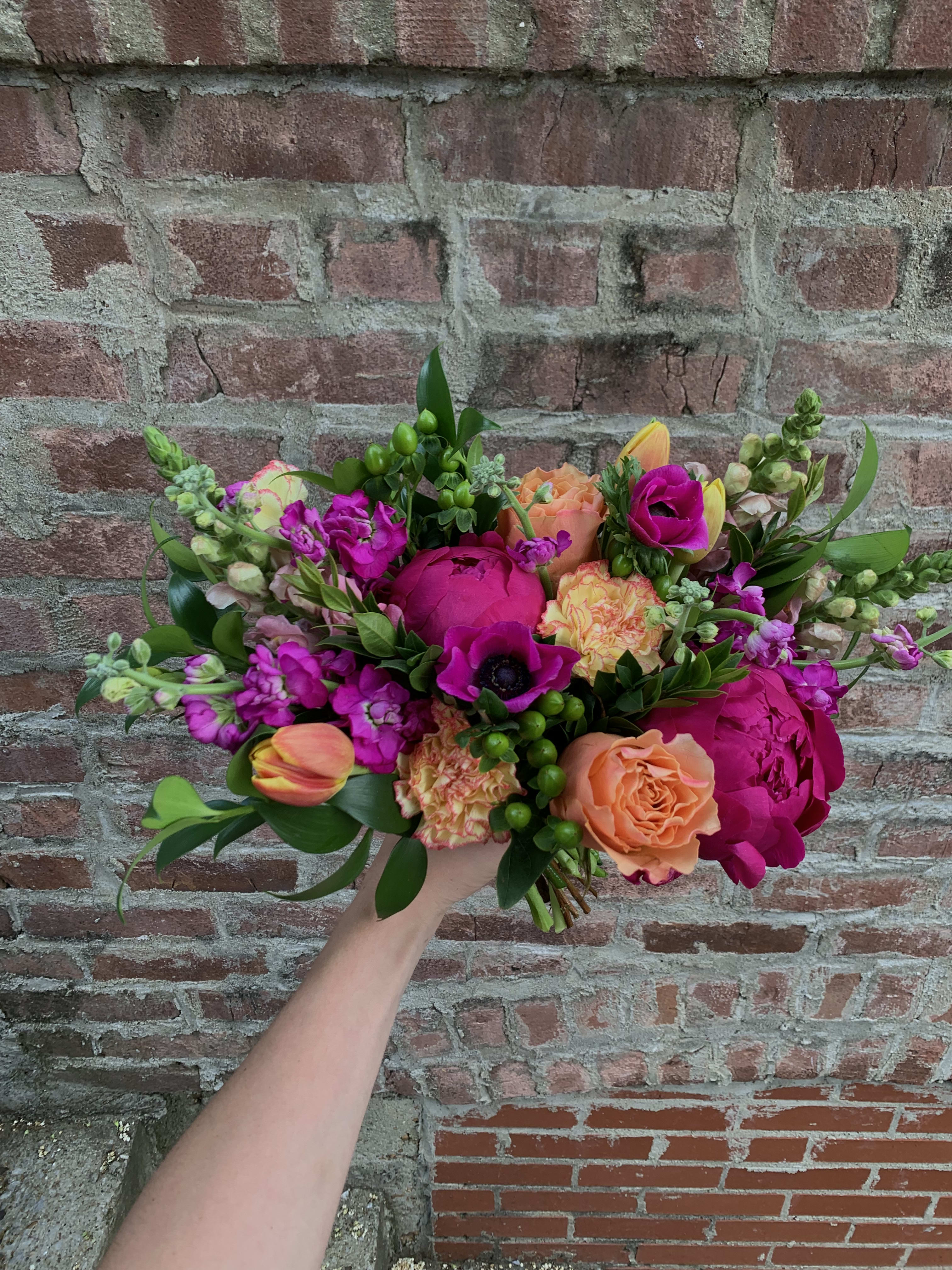 Fuchsia Fun - Snapdragons, peonies, and free spirit roses compliment each other and make this a premium but unique arrangement.