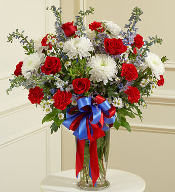 Beautiful Blessings Vase Arrangement patriotic - Product ID: 91300   91300 Red White and Blue Large Sympathy Vase Arrangement Send a patriotic tribute to a beloved veteran with this red, white and blue arrangement. Features the freshest red roses, white cremones, blue delphiniums and more Accented with myrtle, spiral eucalyptus and more Presented in a classic clear glass vase Our florists choose only the freshest flowers available, so colors and varieties may vary Vase measures 11&quot;H Arrangement measures approximately 26âH