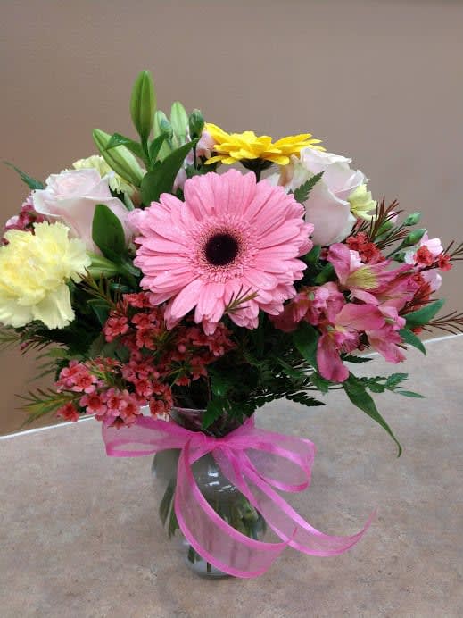 Spring Beauty Spring Beauty - A Beautiful Mixed Bouquet Of Carnations, Roses, Gerbs, Lilies and Alstro In A Clear Vase.