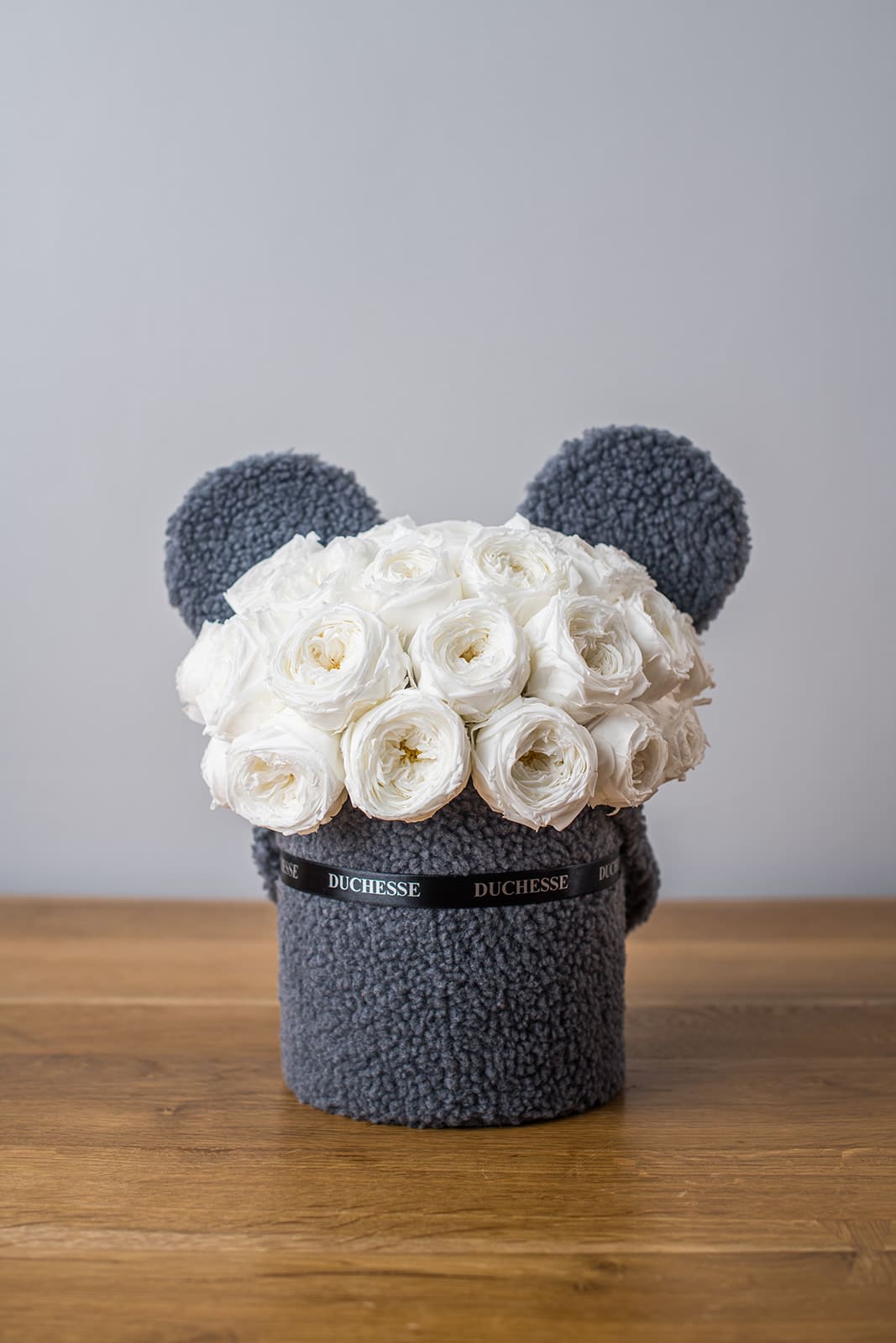 Mommy &amp; Me White - Bucket-style container with soft, fuzzy exterior Cute pop-up animal ears Round bouquet style Choose from three colors of blooms and two containers Perfect for baby showers and early birthdays, the Mommy &amp; Me White is a precious floral gift that lasts up to three years. These preserved flower arrangements will delight moms and dads-to-be, serving as both a thoughtful gift and elegant nursery décor. The Mommy &amp; Me White is a wonderful gift to bring to the hospital to welcome newborns, as it requires no watering, fertilizing, or other involved care — something that new parents simply don’t have time for with fresh flowers. The mommy &amp; me is also the perfect choice to say “good job” to little flower lovers after recitals, performances, and other activities.