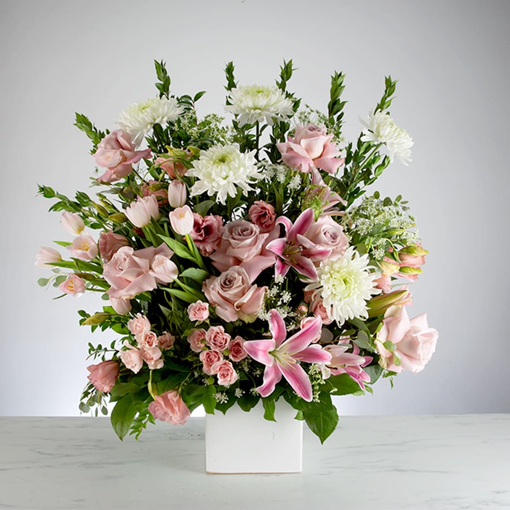 Pink Mache - This pink and white funeral basket is a lovely sendoff and tribute. Fitting for any type of ceremony. 