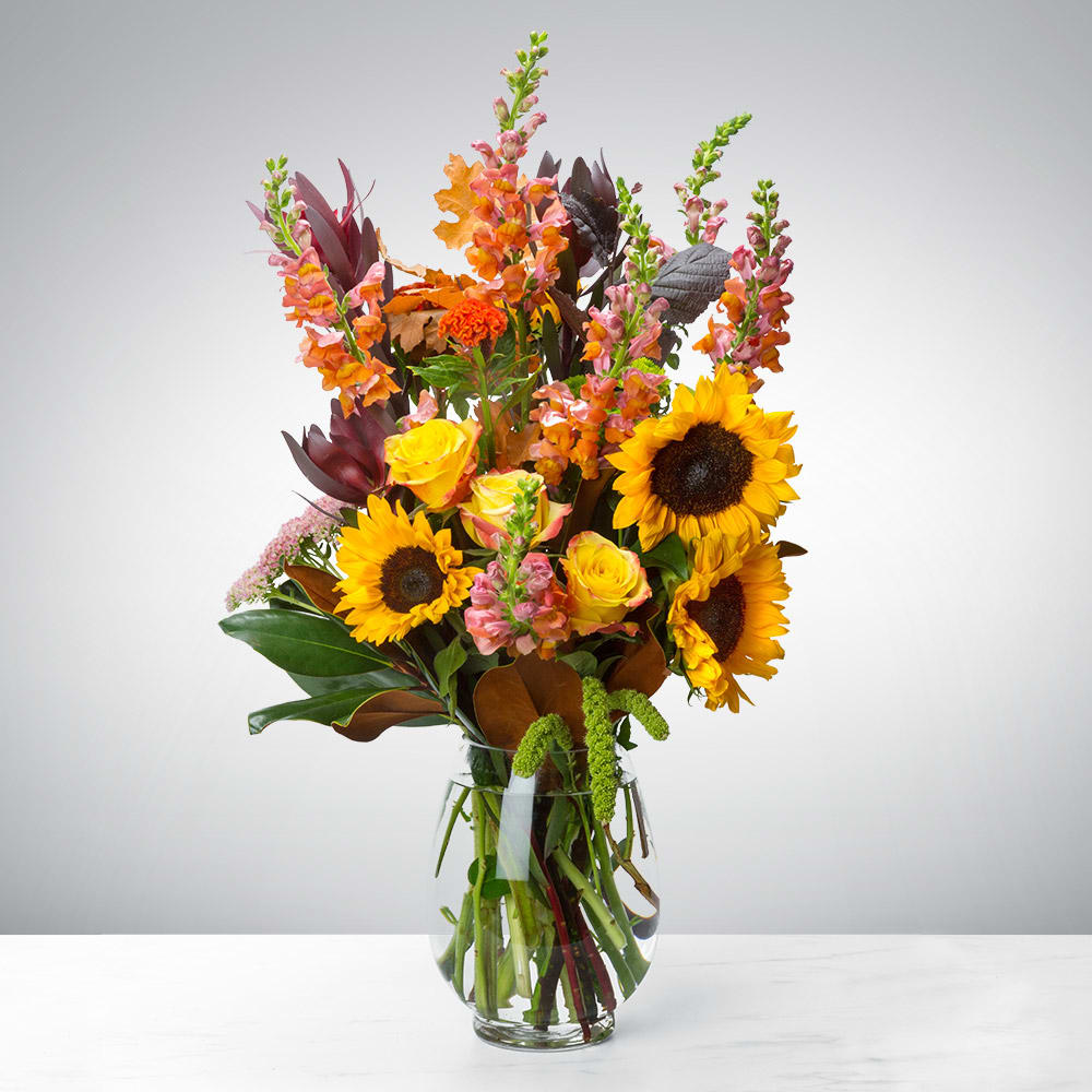 Hello Fall  - Say hello to the new season with this tower of fall flowers! Featuring a wide array of seasonal blooms, this arrangement has something for everyone, and is sure to bedazzle whoever welcomes it into their life. Say “hello” to someone in your life with this fall flower tower. 