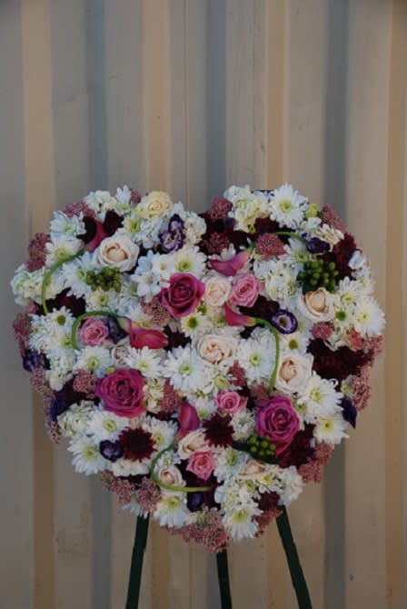 Precious Heart - The precious heart is a solid heart arrangement with white hydrangeas, freesias, chrysanthemums, roses, and lavender, calla lilies, roses, lisianthus, chrysanthemums, and green coffee beans.